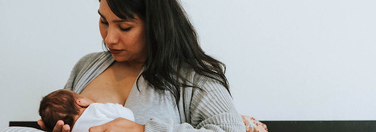 Lady breastfeeding her newborn.