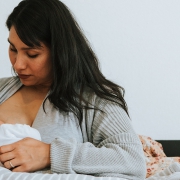 Lady breastfeeding her newborn.