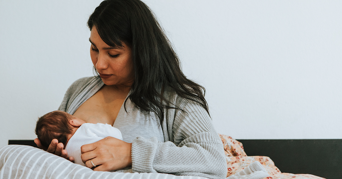 Lady breastfeeding her newborn.