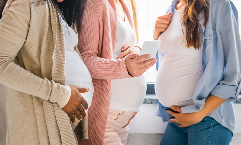 Three pregnant women’s bellies.