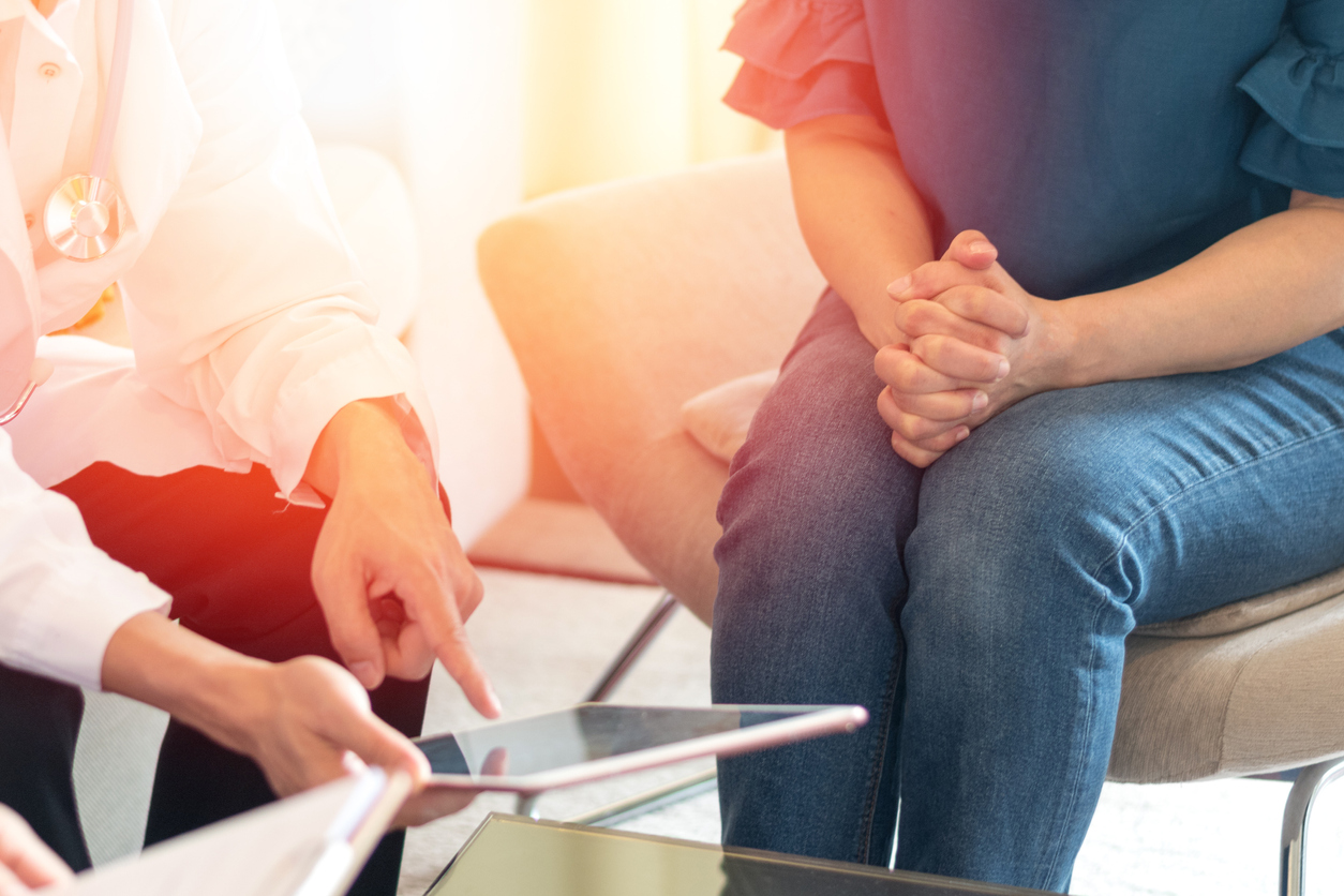 Doctors and patient healthcare concept. Gynecologist physician team consulting and examining woman patient health in Obstetrics and Gynecology department in medical hospital health service center, discussing gynecological cancers..