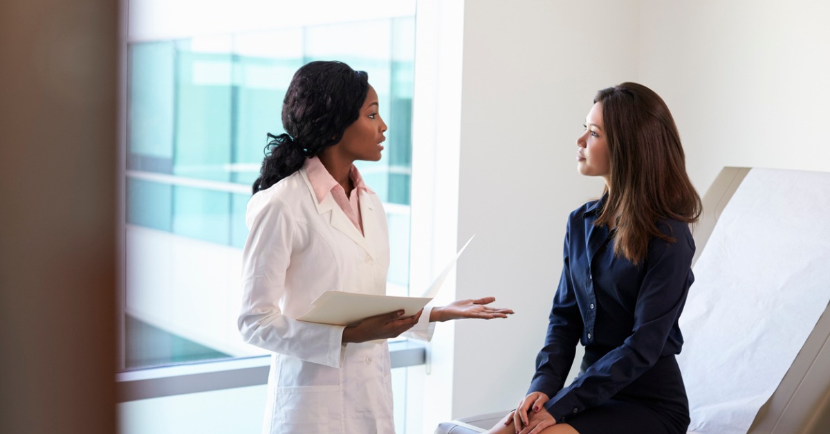 Female Doctor Meeting With Patient In Exam Room