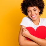 beautiful woman hugging a heart shape