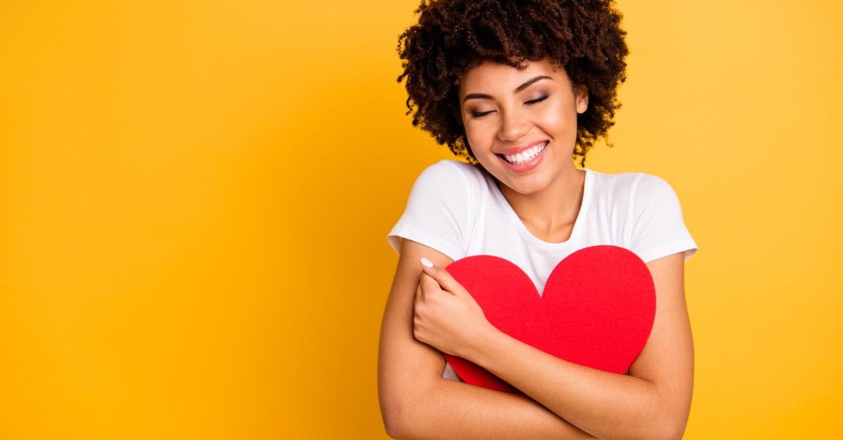 beautiful woman hugging a heart shape