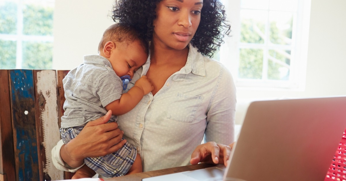 Mother with baby working in home office