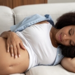 pregnant woman lying on couch