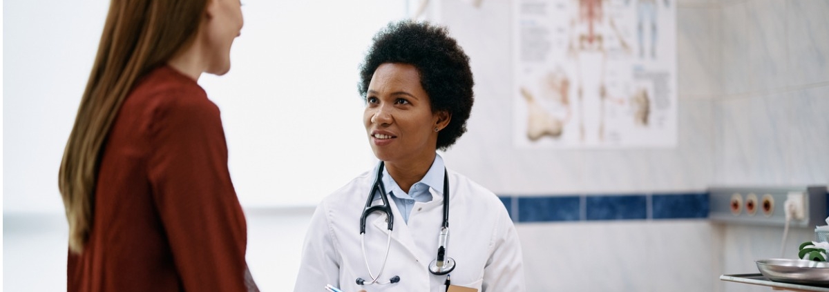 Doctor speaking to woman during medical appointment