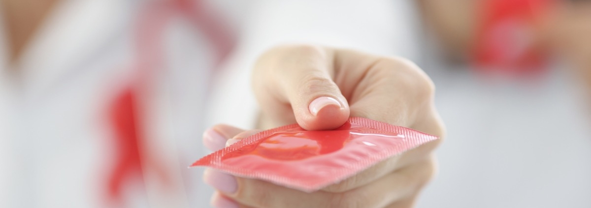 Doctor holding condom in clinic
