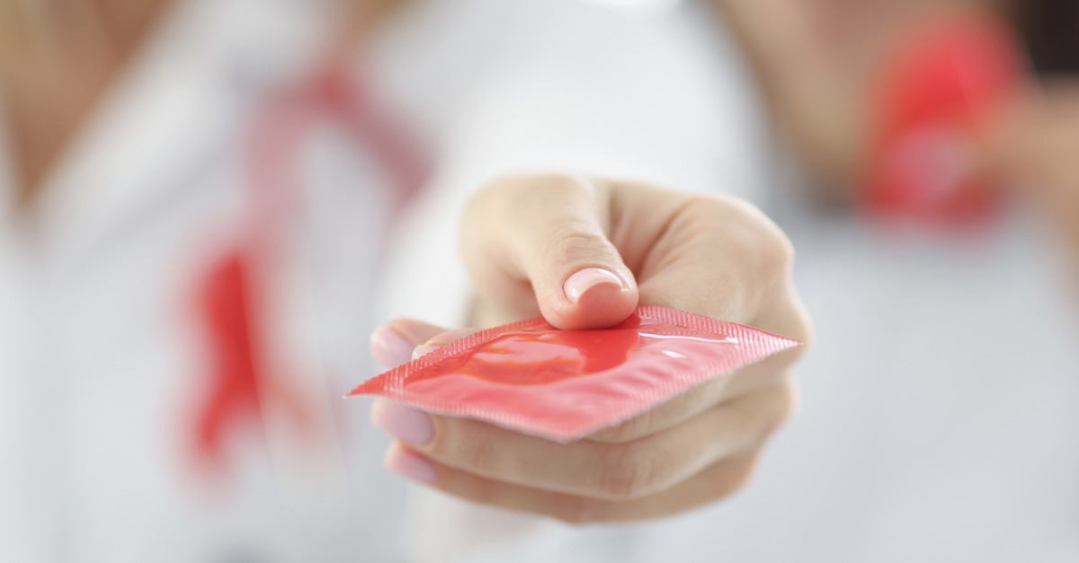 Doctor holding condom in clinic