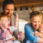 young family making cookies at home