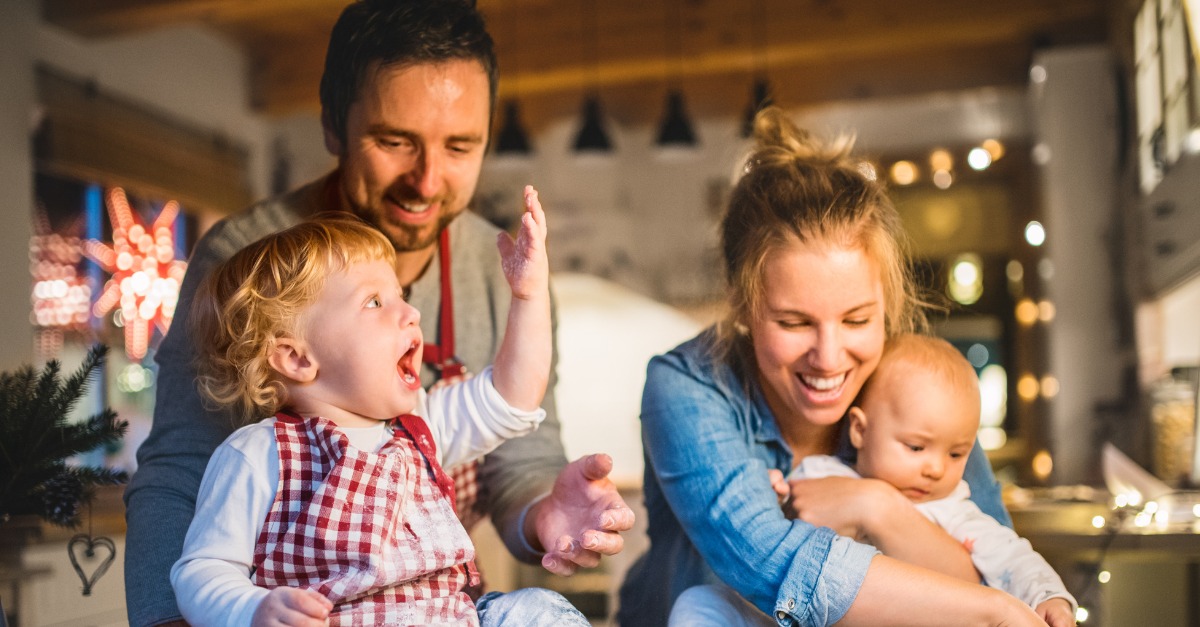 young family making cookies at home