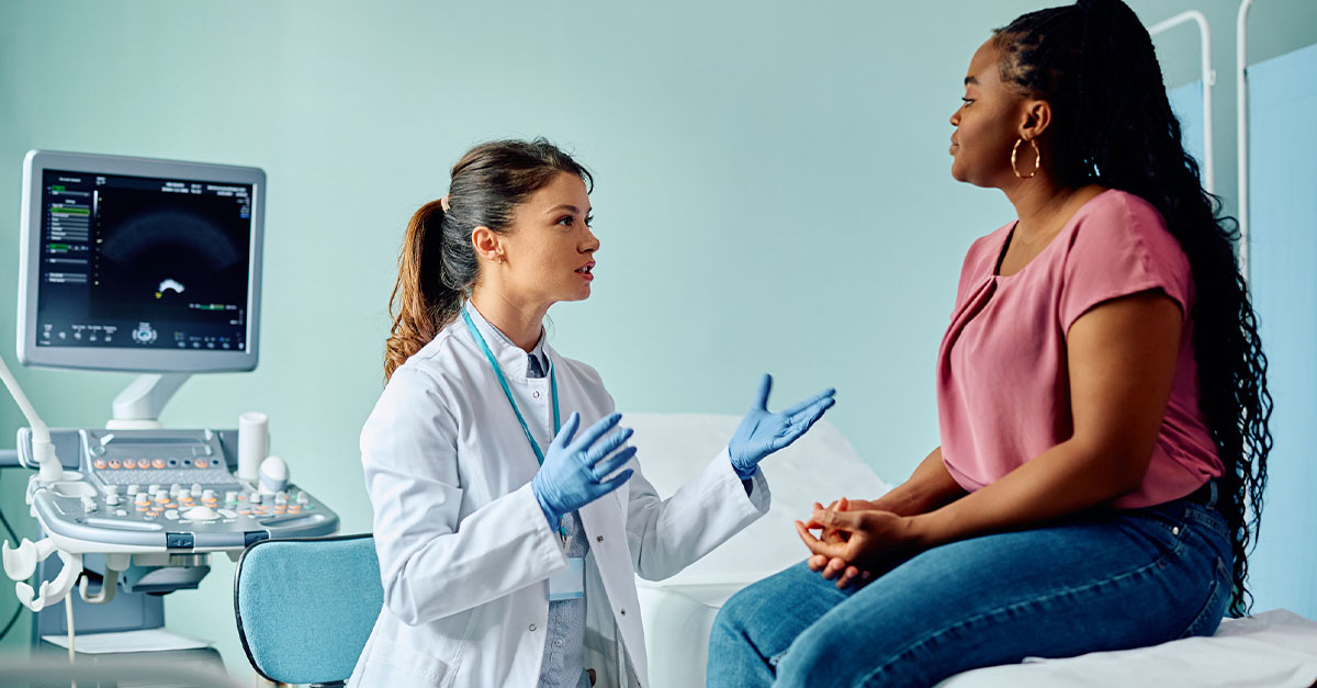 A patient speaking to her gynecologist at a medical examination.