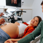 Pregnant lady receiving an ultrasound at a Maternity Clinic with her husband.