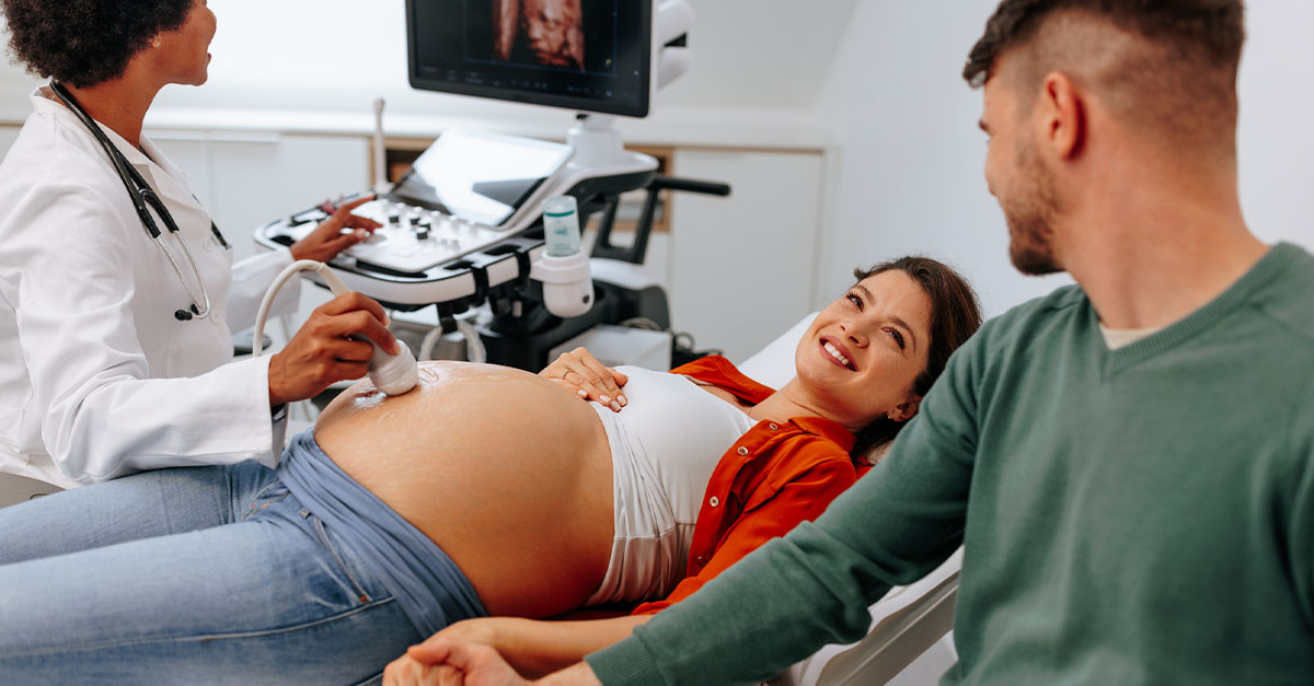 Pregnant lady receiving an ultrasound at a Maternity Clinic with her husband.