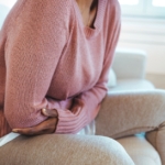 Woman on couch with menstrual pain