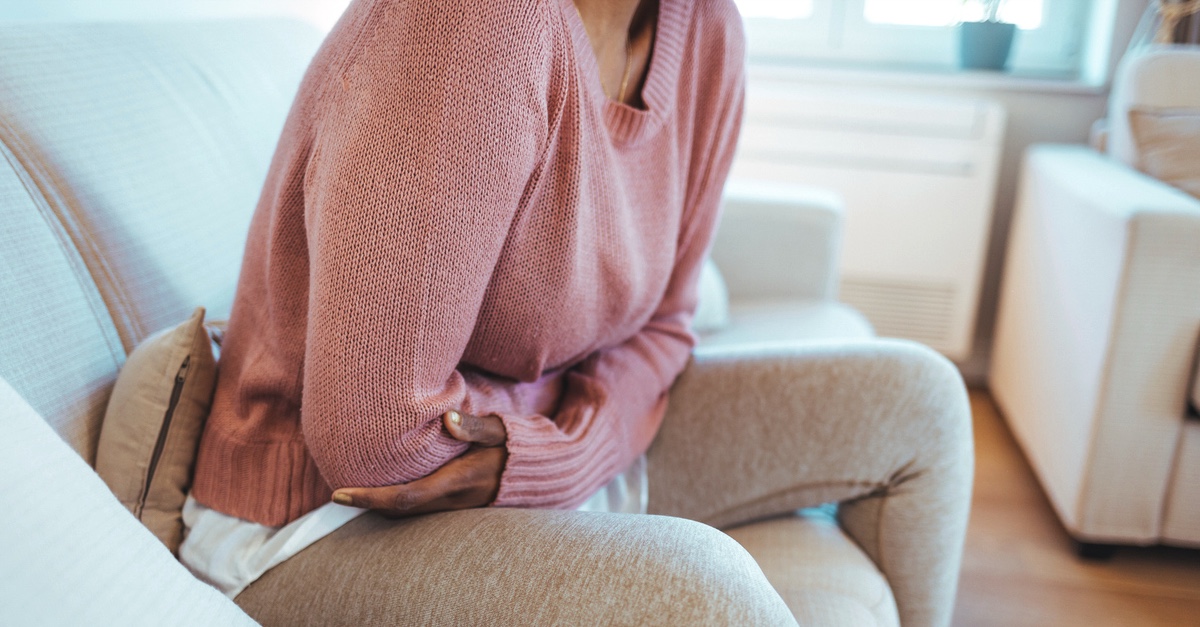 Woman on couch with menstrual pain